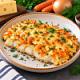 Треска с сыром, яйцом, луком и морковью