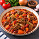 Говядина тушеная с луком, морковью, фасолью, томатами